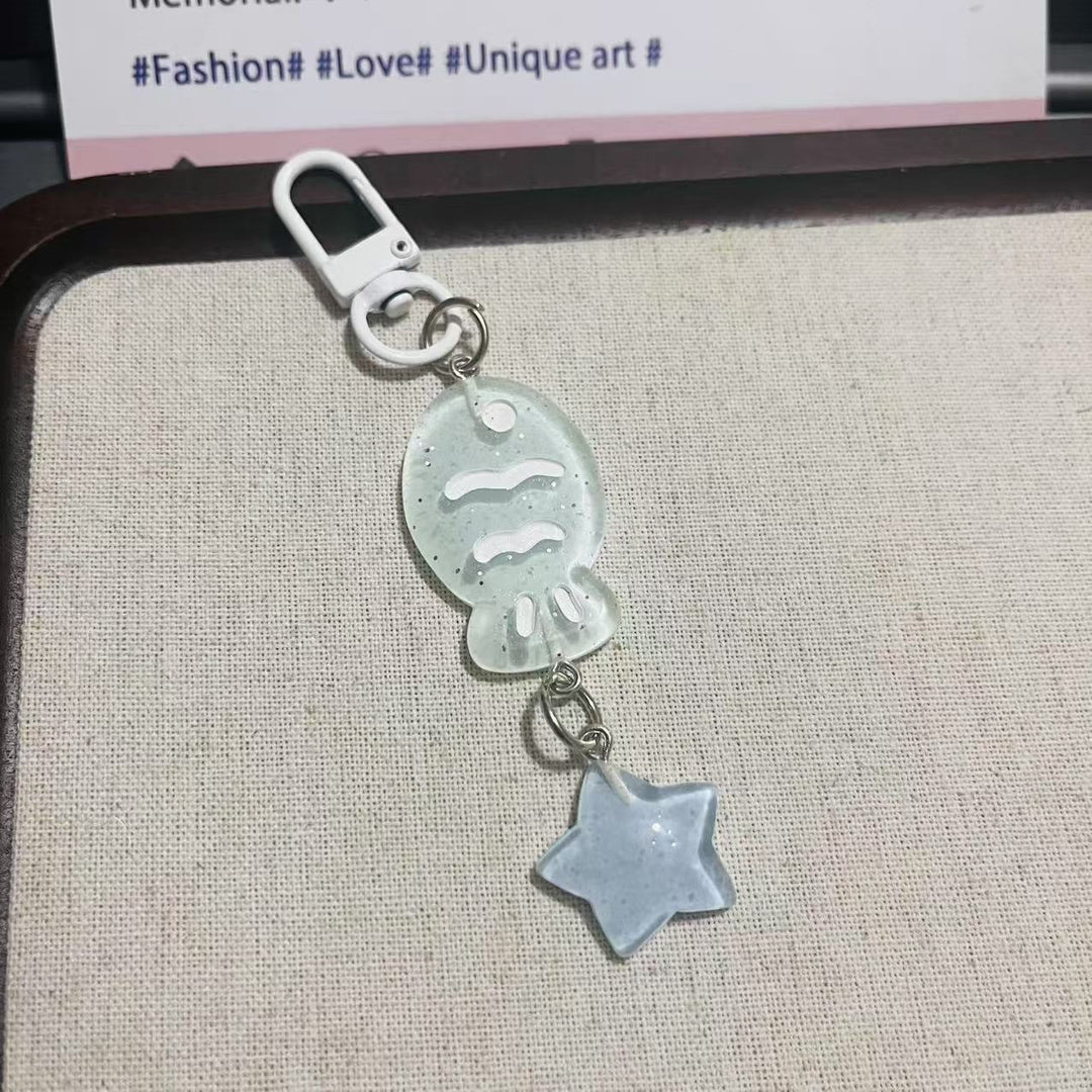 Glistening acrylic fish & star charm keychain, a trendy and cute unisex accessory for any bag.