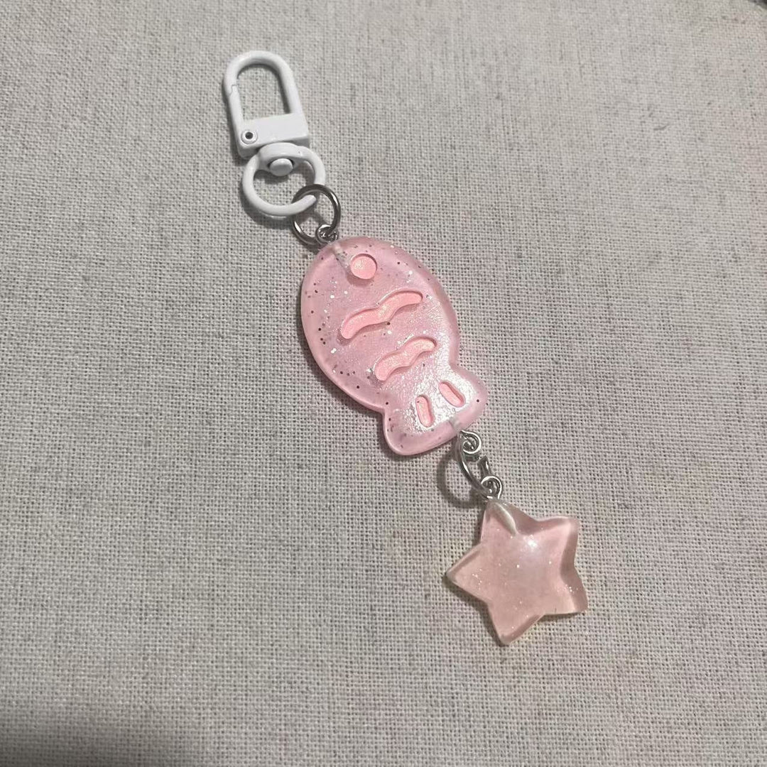 Shiny acrylic fish and star charm keychain, a decorative unisex accessory and bag charm.