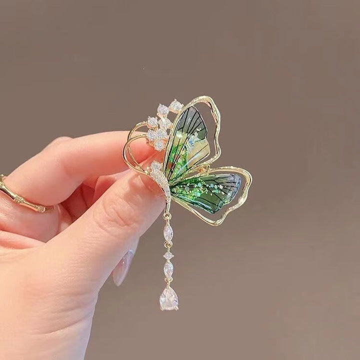 Dazzling women's butterfly brooch featuring sparkling glitter stones, an elegant rhinestone pin for dresses & jackets.