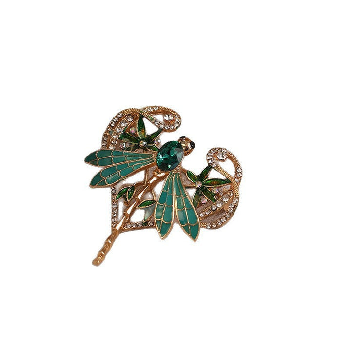 Detailed sparkling crystal dragonfly pin, a women's fashion brooch with intricate rhinestone embellishments.