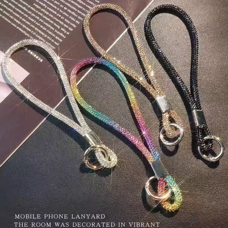 Sparkling crystal wrist strap lanyard for phones, keys, or badges. Glamorous and secure unisex accessory.