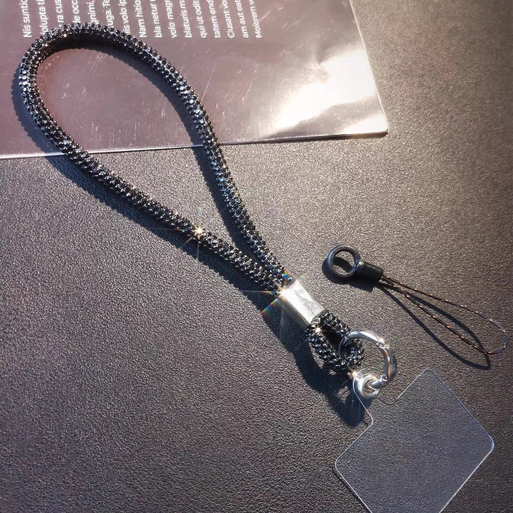 Secure your phone with a sparkling crystal wrist strap lanyard. Unisex fashion accessory prevents drops.