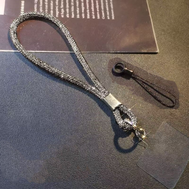 Close-up of sparkling crystal wrist strap lanyard. Versatile accessory for phones, keychains, and badge holders.