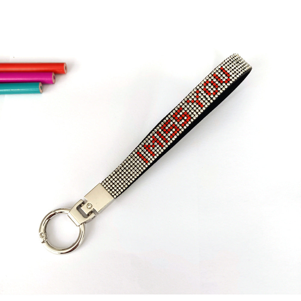 Close-up of sparkling 'I Love You' rhinestone keychain charm, a durable love accessory & key holder.