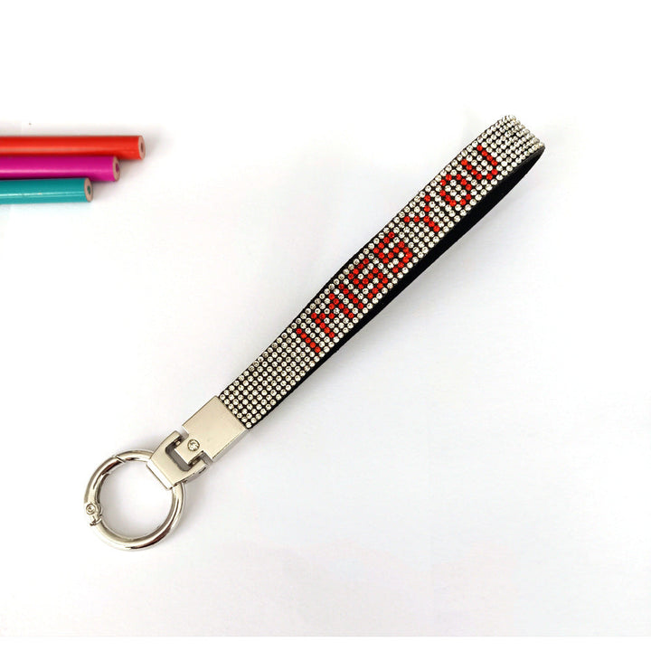 Close-up of sparkling 'I Love You' rhinestone keychain charm, a durable love accessory & key holder.