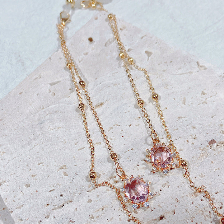 Sparkling pink crystal pendant necklace for women, elegant fashion jewelry with a faceted teardrop design.