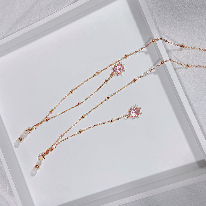 Close-up of a dazzling pink crystal teardrop pendant necklace, exquisite women's fashion jewelry.