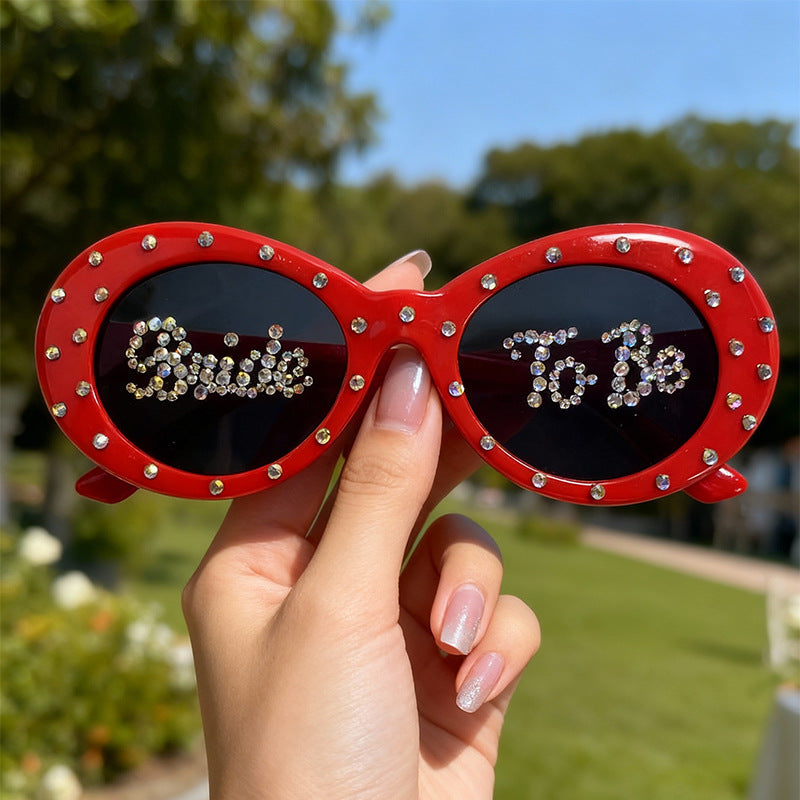 Glamorous cat-eye sunglasses with sparkling rhinestones, a chic bridal or party accessory.