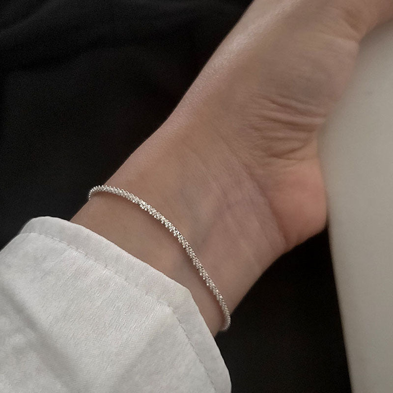 Close-up of a women's adjustable crystal anklet, featuring dazzling silver-tone stones. A chic foot accessory.