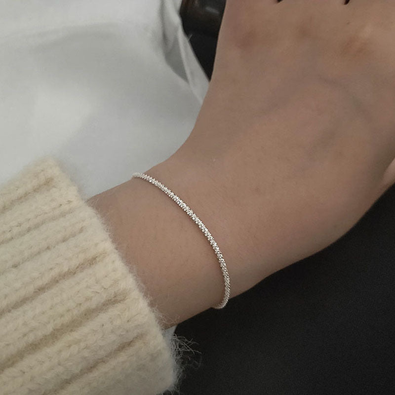 Women's sparkling crystal ankle bracelet on a foot, ideal for beach or summer fashion. Adjustable silver anklet.