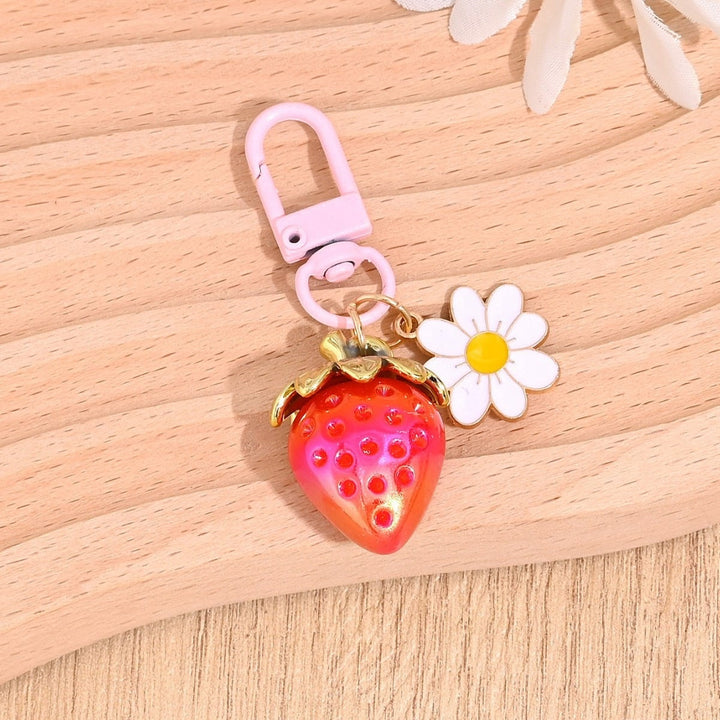 Adorable glitter strawberry charm for backpacks, a stylish touch.