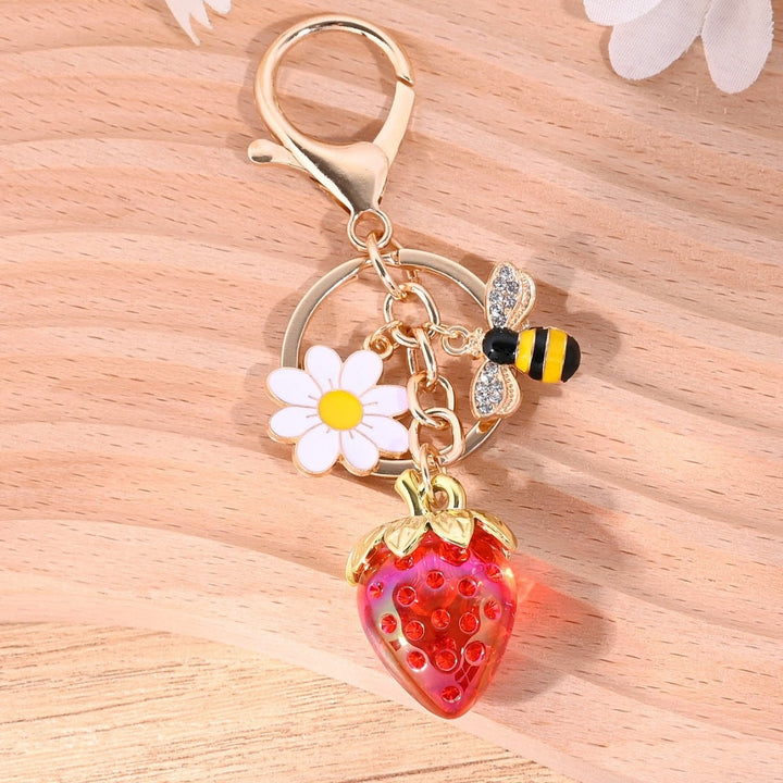 Red sparkling strawberry charm for keys, a festive accent.