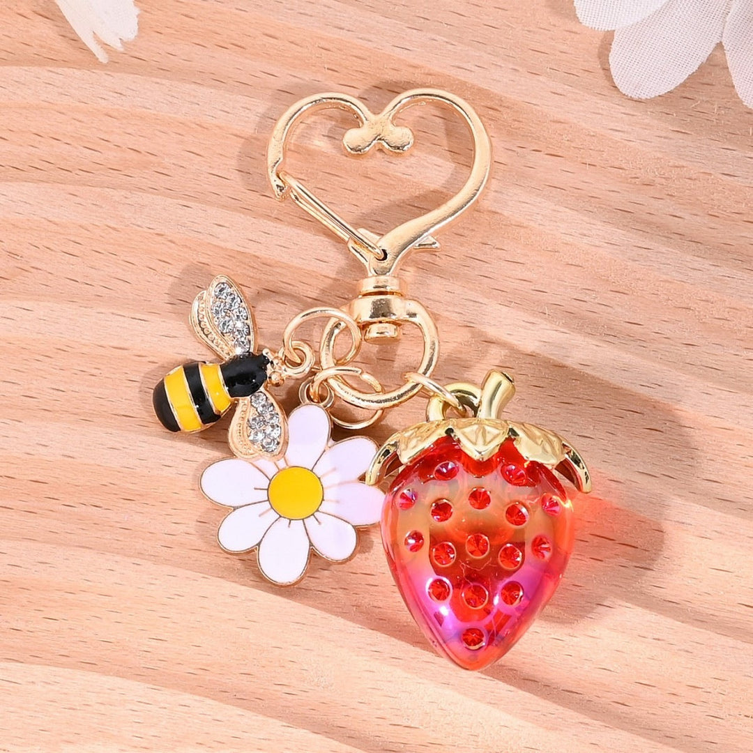Vibrant sparkling strawberry bag charm, catches the eye.