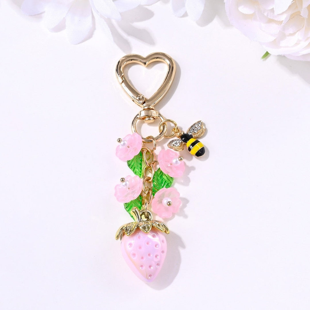 Small sparkling strawberry charm for bag decoration, compact.