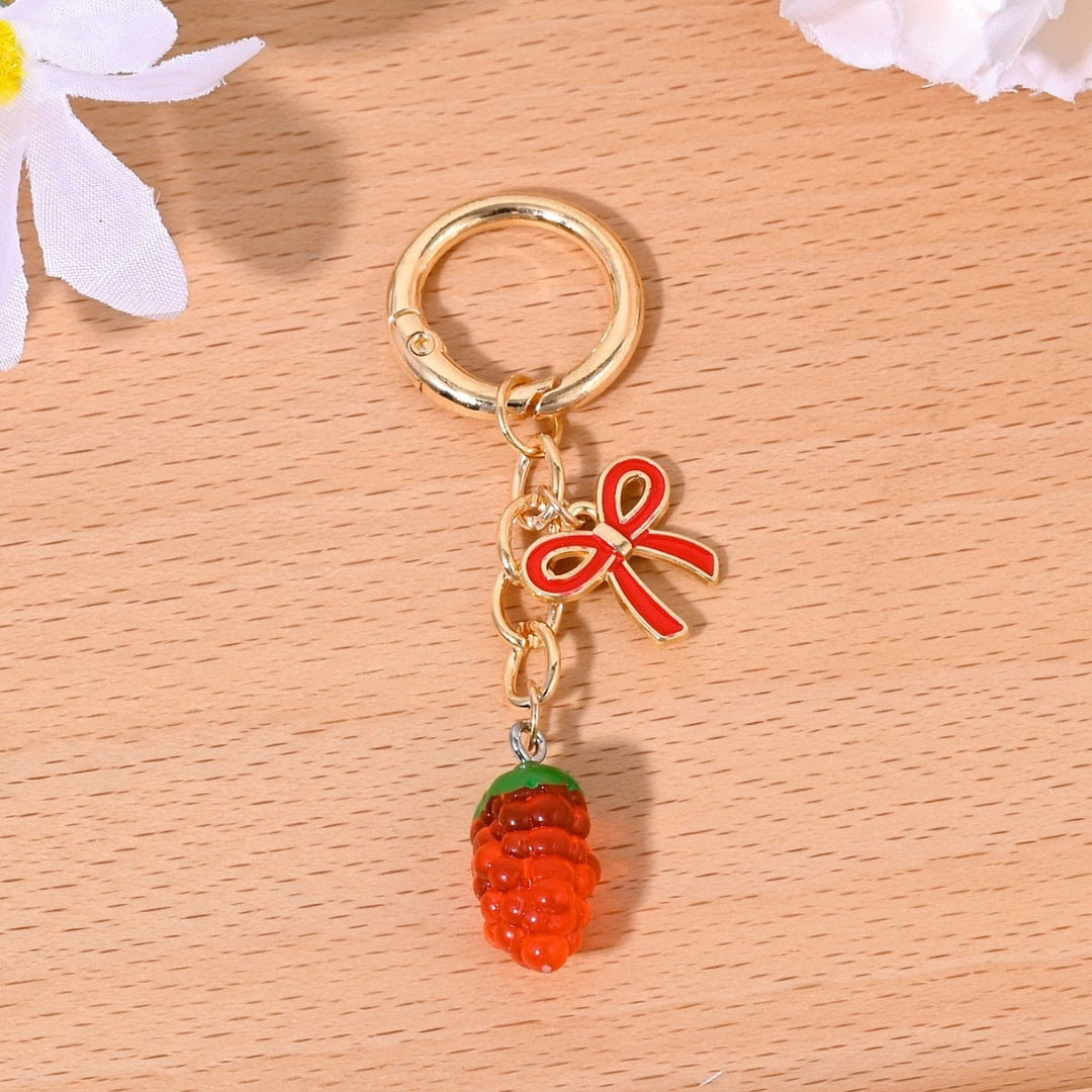Feminine sparkling strawberry bag charm, a beautiful addition.