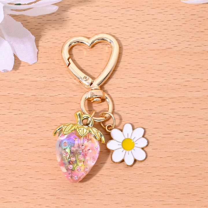 Modern sparkling strawberry keychain accessory, sleek design.