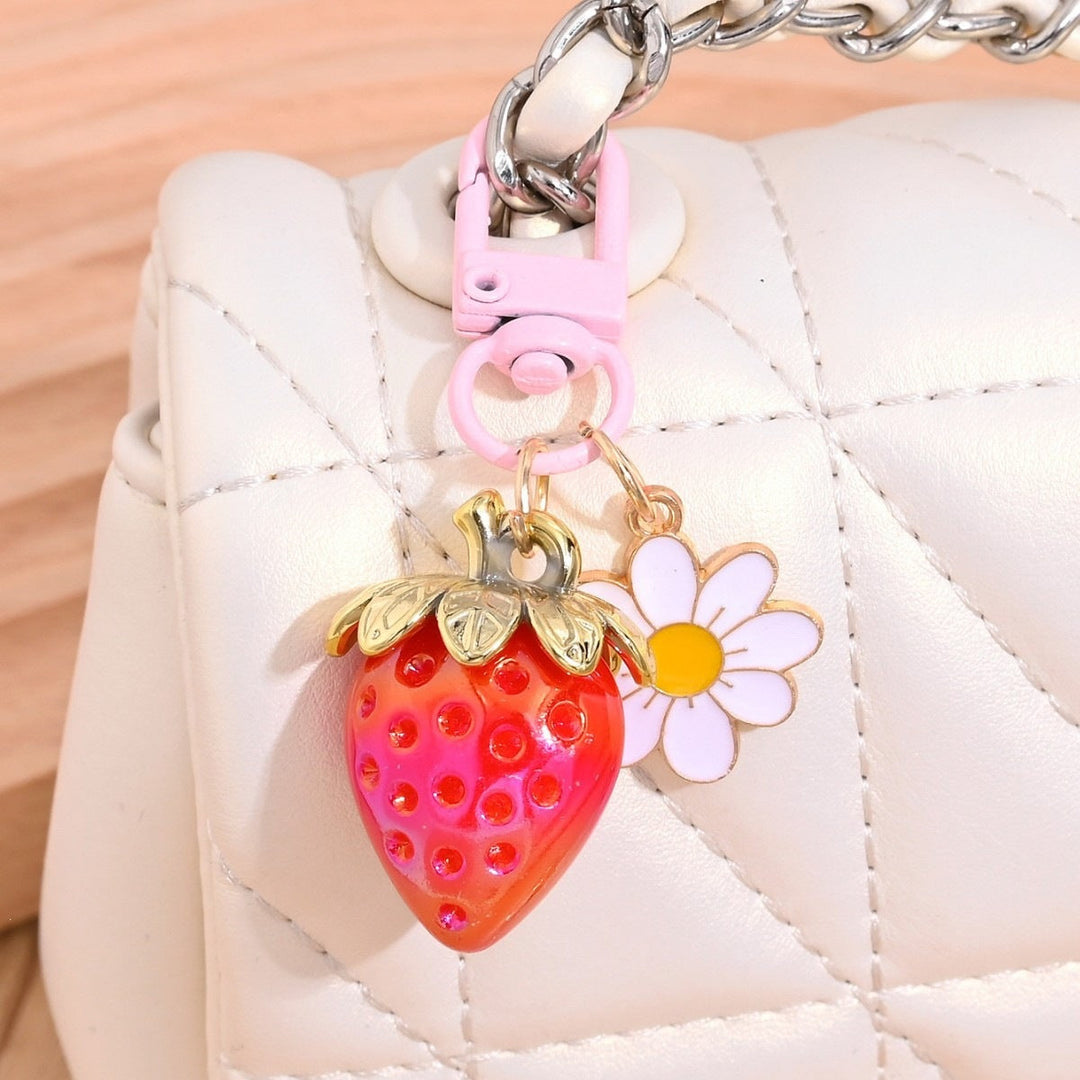 Crystal-studded strawberry keychain, perfect for key organization.