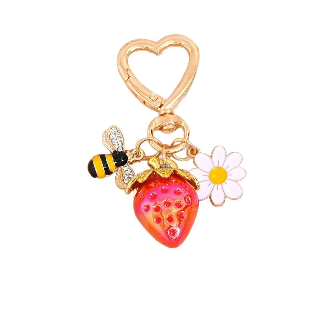 Shiny plastic strawberry charm for keys or purses, a novelty item.
