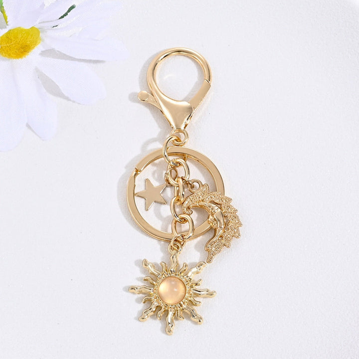 Add to your charm collection: sparkling sun & star key holder, women's design.