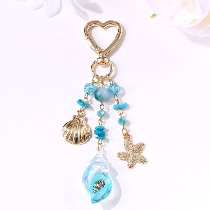Elegant handbag accessory: sparkling sun & star keychain charm.
