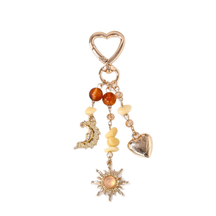 Intricate metal sun and star sparkling charm, ideal for keys or bags.