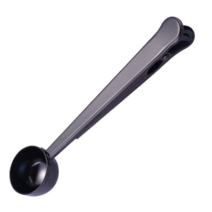 Sleek stainless steel coffee spoon and bag clip, a stylish cafe accessory for optimal coffee freshness.