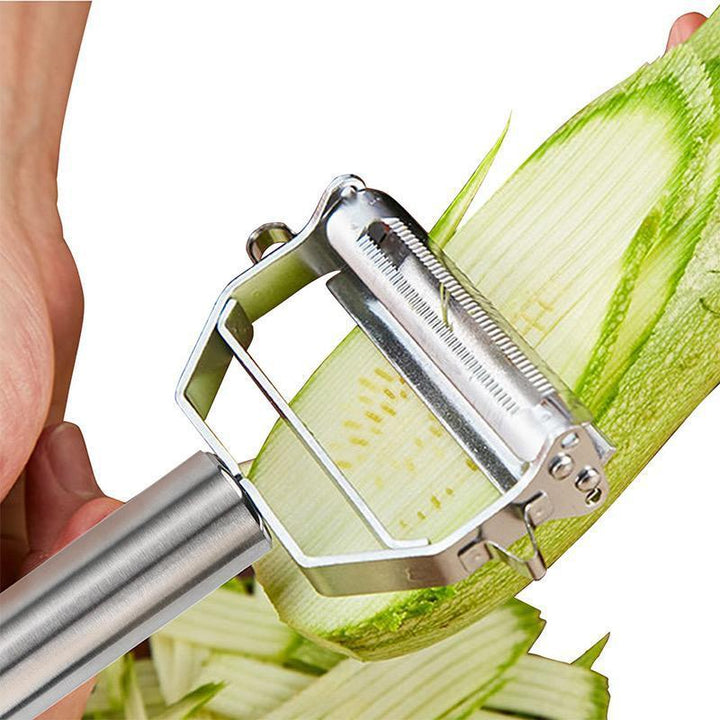 Using the julienne cutter side of the stainless steel kitchen tool to create perfect vegetable strips.