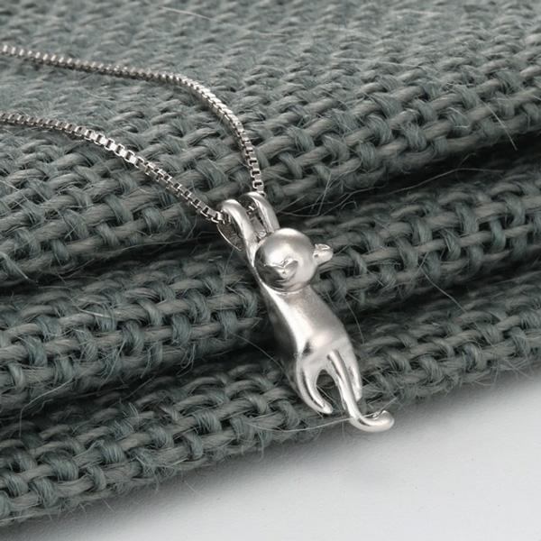 Sterling silver hanging cat pendant necklace for women. Delicate feline jewelry with adjustable chain.