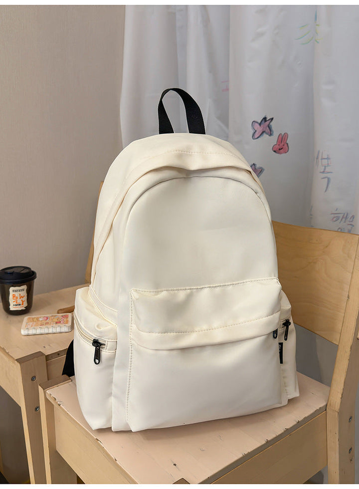Stylish black minimalist unisex backpack. Multi-functional nylon bag for school, daily commute, & travel. Everyday carry.