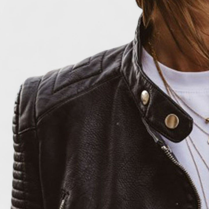 Fitted women's fashion jacket, black, featuring a full zipper, stand collar, and unique accent pockets. Versatile.