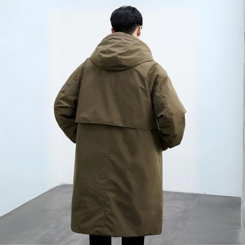 Fashionable man wearing a hooded long trench coat, ideal versatile outerwear for men's autumn & winter city fashion.