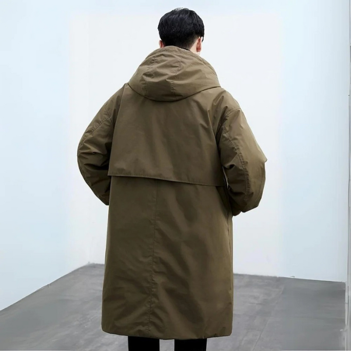 Fashionable man wearing a hooded long trench coat, ideal versatile outerwear for men's autumn & winter city fashion.