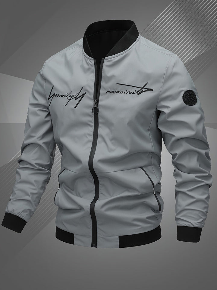Detailed texture of the men's versatile bomber jacket, featuring a sturdy zip for stylish outerwear.