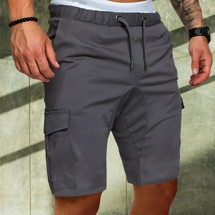 Man wearing stylish men's cargo shorts, demonstrating comfort and flexibility for travel & outdoor activities.