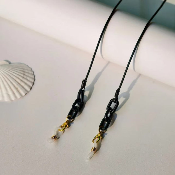 Stylish eyeglass chain on a model. Keeps spectacles secure. Multifunctional glasses holder & lanyard.