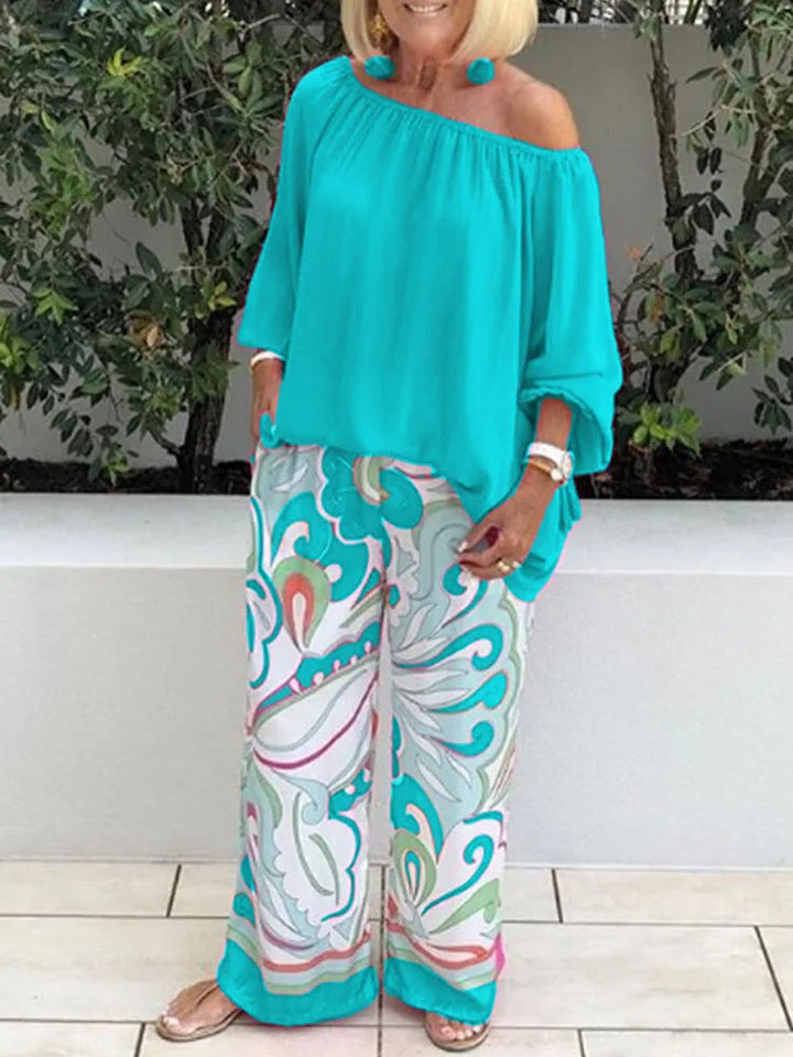 Women's relaxed fit off-shoulder two-piece outfit. Includes a chic top with lantern sleeves & flowy wide-leg pants.