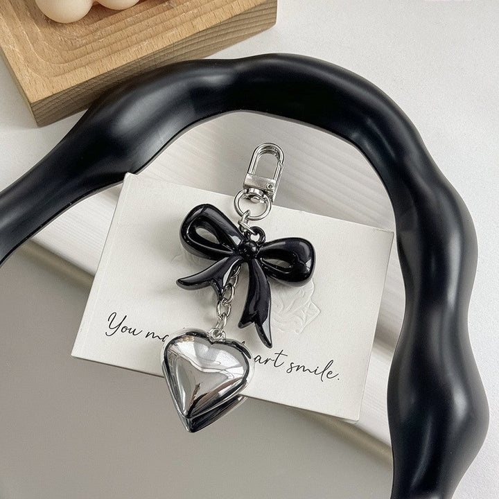 Women's gift idea: a beautiful purple heart keychain, a versatile bag charm and key accessory.