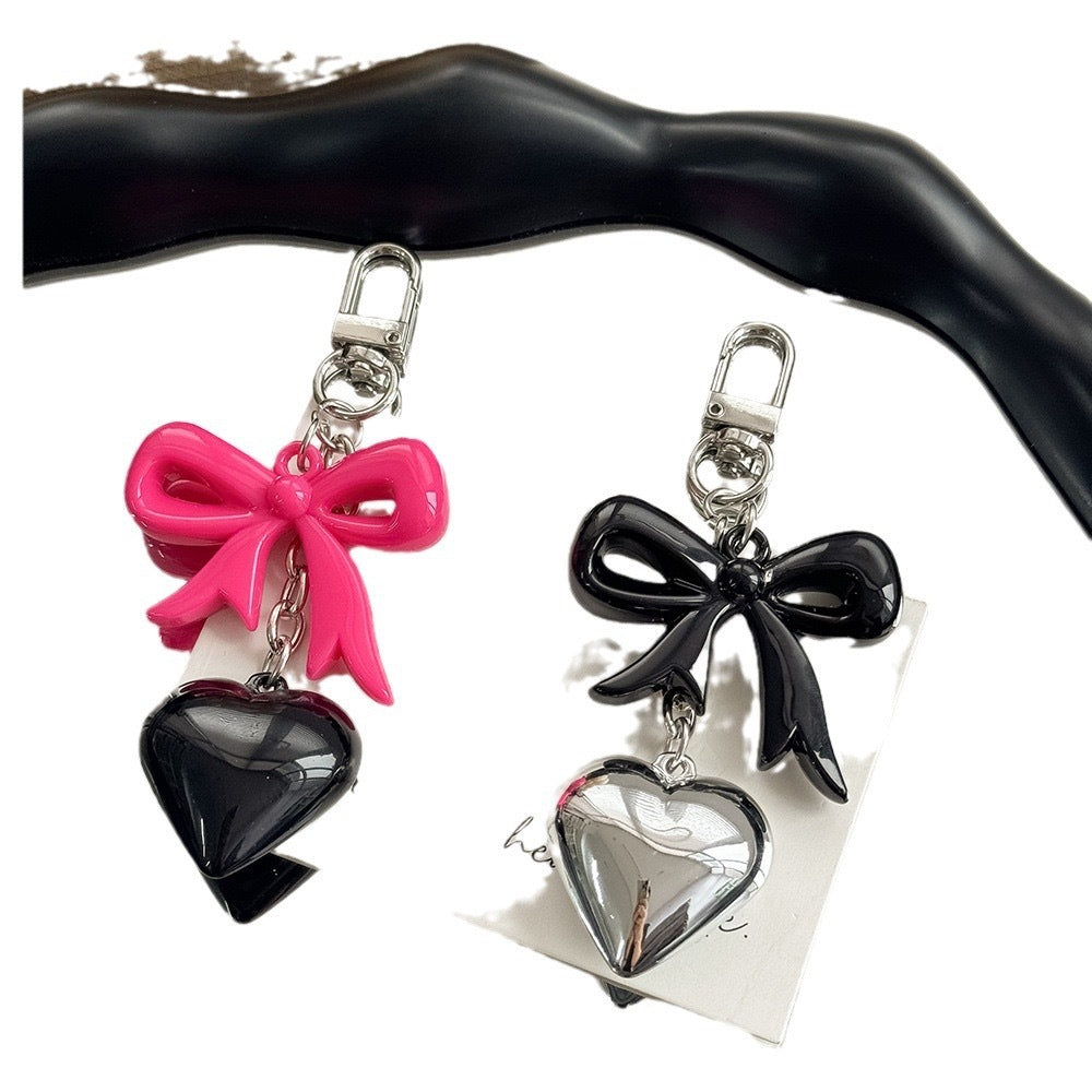 Close-up of a stylish purple heart charm keychain, a great gift idea for women's bags.