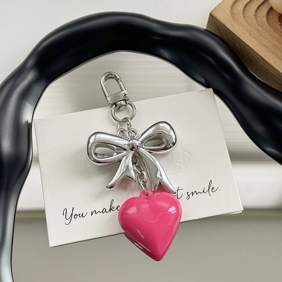 Women's fashion accessory: a sleek purple heart charm keychain for bags or keys.
