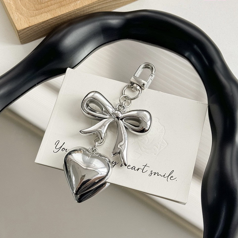 Elegant purple heart charm keychain, ideal for women seeking a fashionable bag accessory.