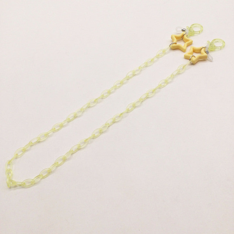 Woman wearing a stylish star charm eyeglass holder chain, keeping her glasses easily accessible.