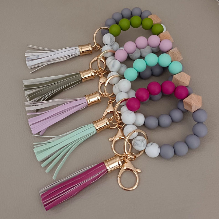 Durable silicone and vibrant beads form this chic unisex keychain bracelet, a modern accessory.