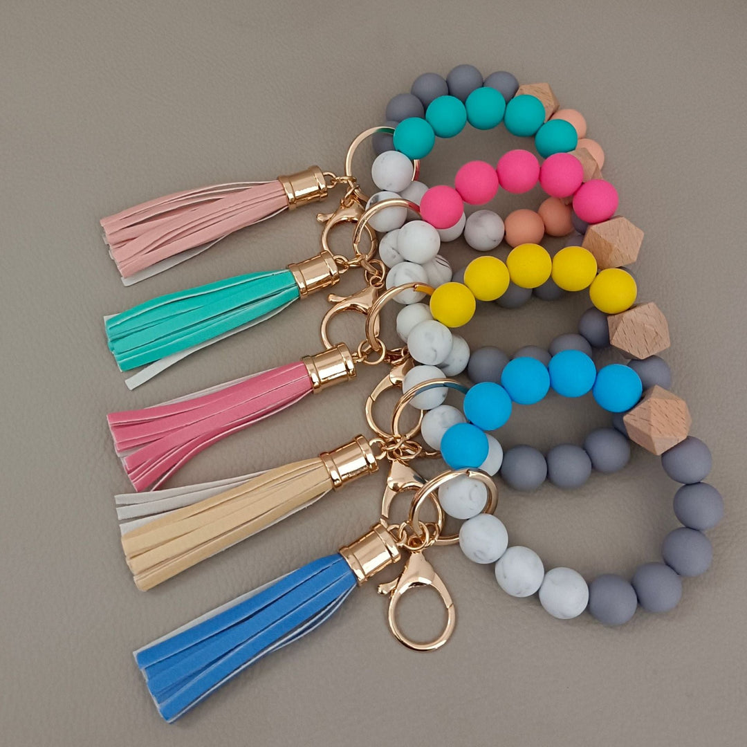 Fashionable beaded bracelet keychain keeps keys handy; a stylish unisex bag accessory and gift.