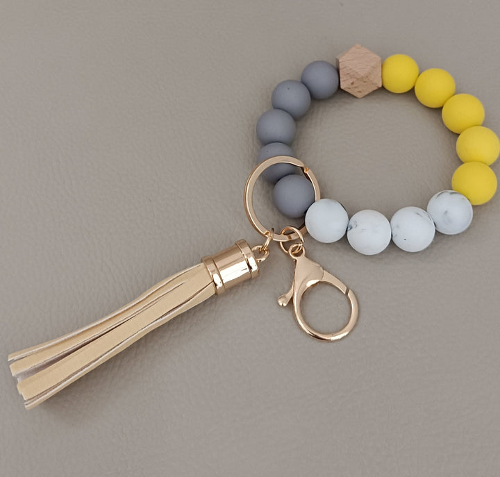 Close-up of a vibrant beaded keychain bracelet with smooth silicone, unisex fashion style.