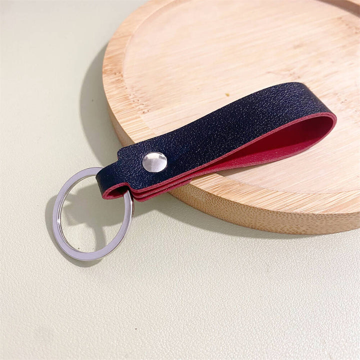 Sleek black leather keyring, a minimalist yet elegant accessory for keys & bags. Durable and timeless.