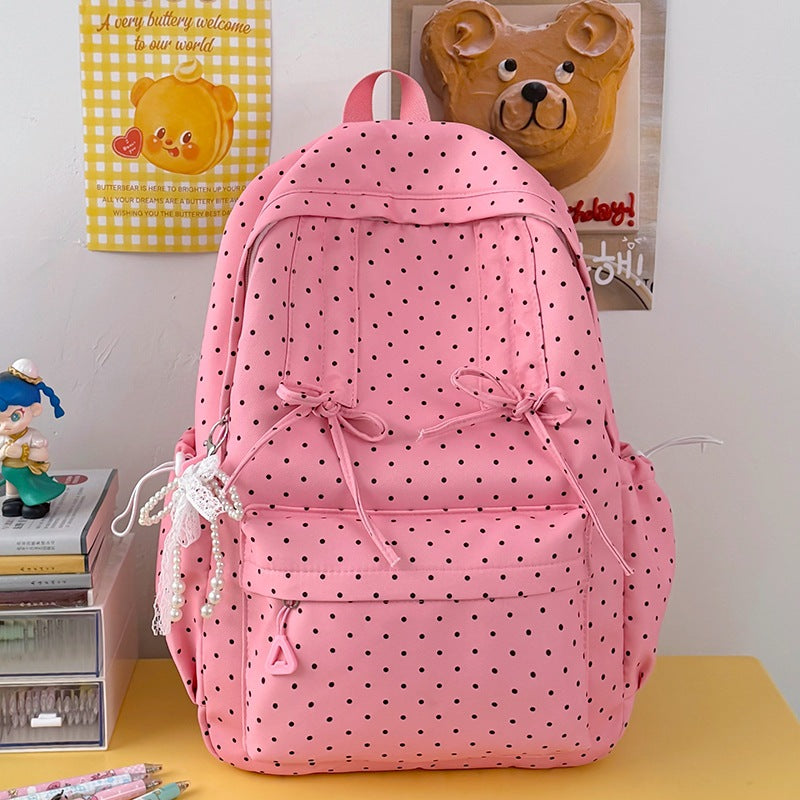 Stylish women's black and white polka dot school backpack with spacious compartments & sturdy straps.