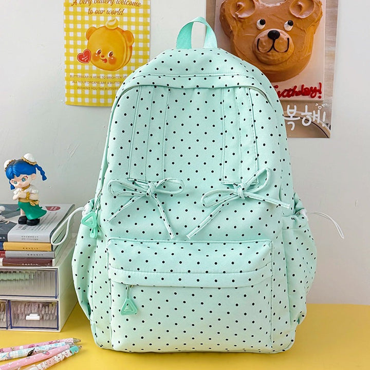 Black & white polka dot women's casual backpack featuring multiple pockets and durable zippers for daily use.