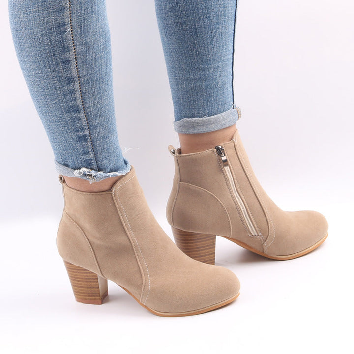 Stylish women's black ankle boots with chunky heel, round toe, and practical side zip closure for autumn fashion.