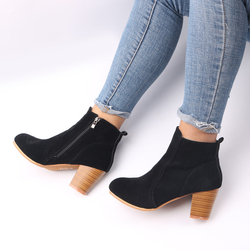 Elegant women's ankle boots for winter, featuring a sturdy chunky heel, sleek design, and easy-access side zipper.