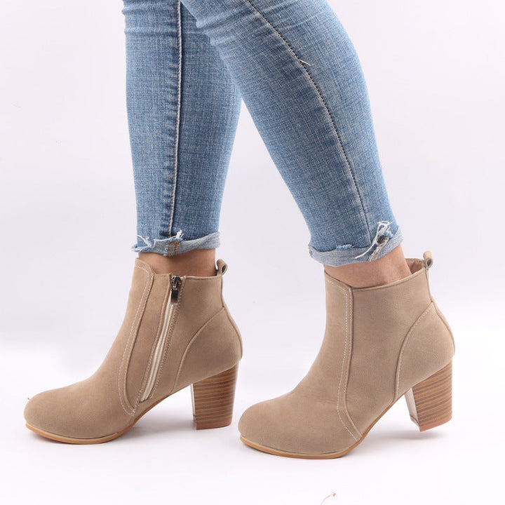 Versatile women's footwear: black ankle boots with a trendy chunky heel, classic round toe, and practical side zip.